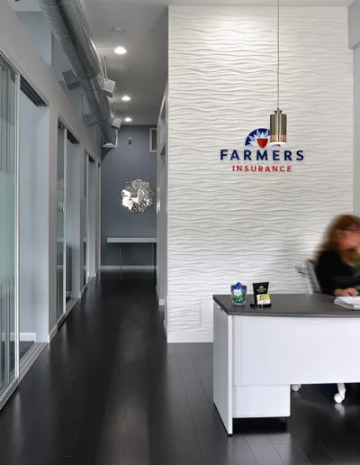 A woman sits at a desk in an office.