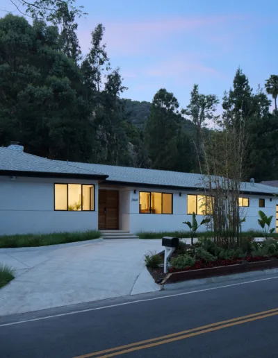 A house with trees and a road.