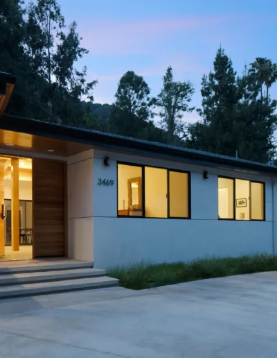 A house with a driveway and trees.