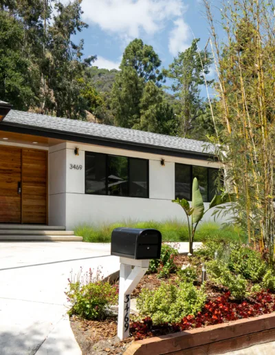 A house with a mailbox and trees.