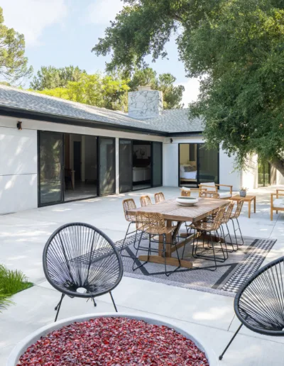 A patio with chairs and a table.