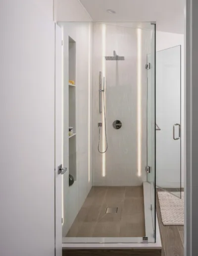 A modern bathroom with a glass shower stall.