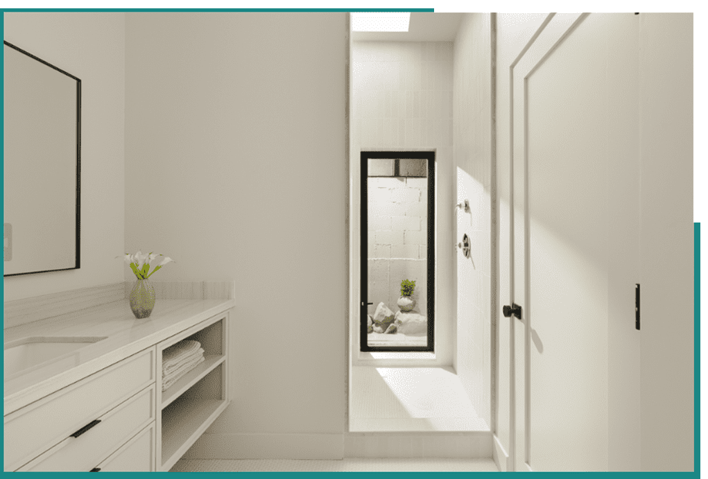 A white bathroom with a glass shower door.